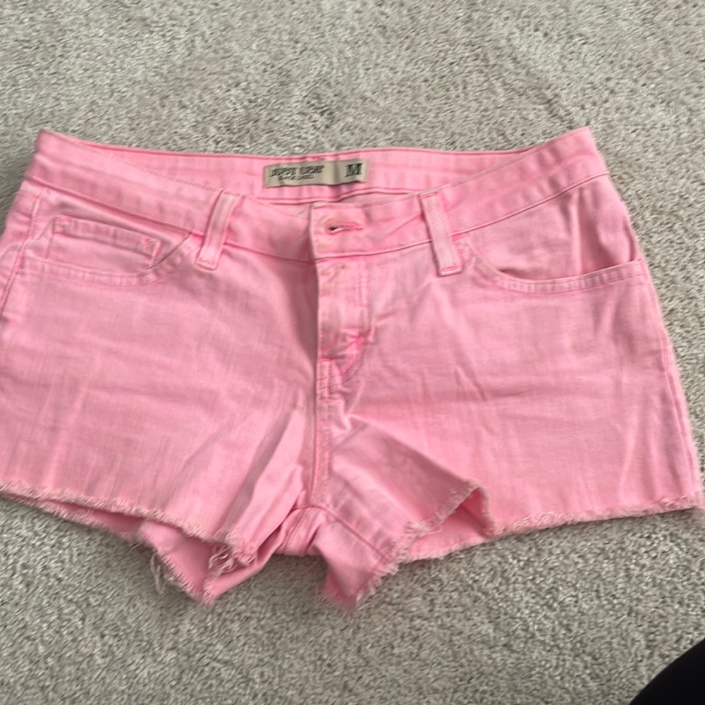 Neon pink cutoff shorts